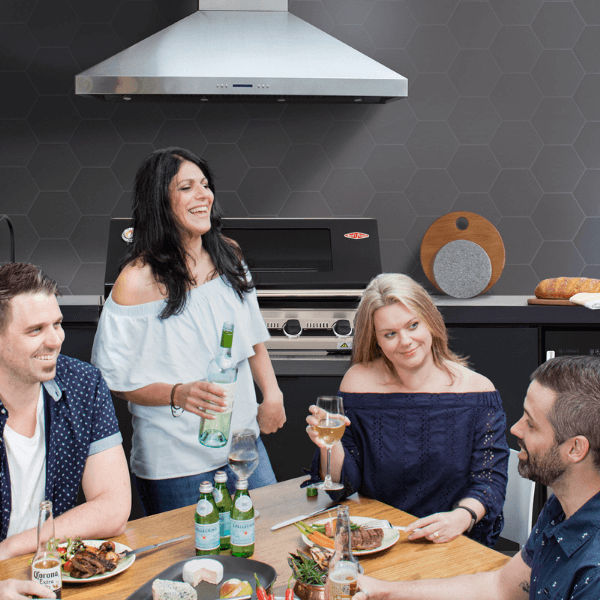 Outdoor kitchen setup with friends enjoying drinks